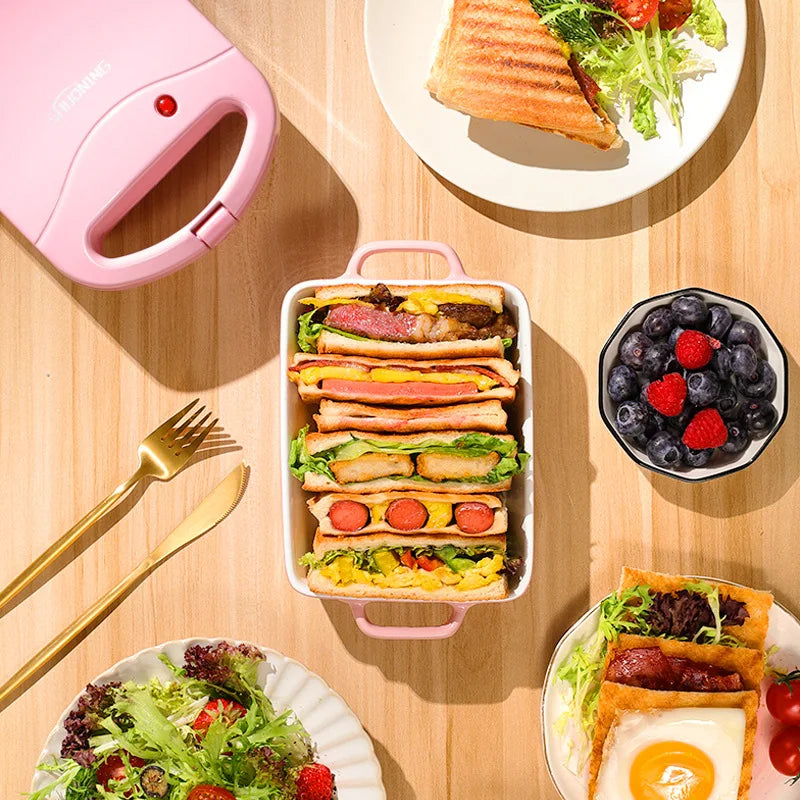 Sandwichera eléctrica portátil, máquina multifuncional para el hogar, antiadherente, para preparar desayunos, gofres y otros alimentos. Color rosa y rojo.
