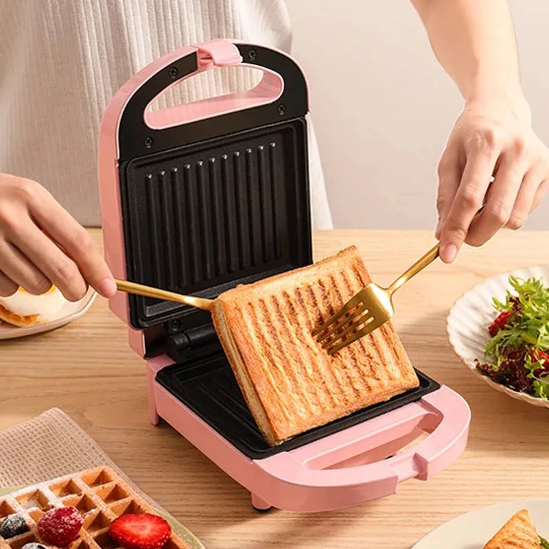 Sandwichera eléctrica portátil, máquina multifuncional para el hogar, antiadherente, para preparar desayunos, gofres y otros alimentos. Color rosa y rojo.