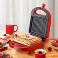 Sandwichera eléctrica portátil, máquina multifuncional para el hogar, antiadherente, para preparar desayunos, gofres y otros alimentos. Color rosa y rojo.