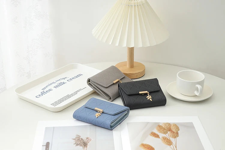 Cartera corta para mujer, nueva, de otoño e invierno, fabricada en Japón y Corea del Sur, pequeña, fresca, de PU, plegable, con colgante de hoja y tres pliegues.