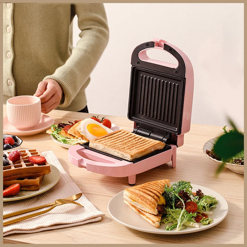 Sandwichera eléctrica portátil, máquina multifuncional para el hogar, antiadherente, para preparar desayunos, gofres y otros alimentos. Color rosa y rojo.