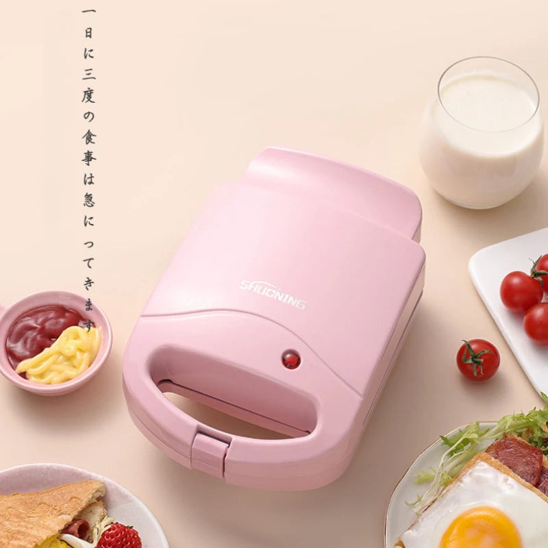 Sandwichera eléctrica portátil, máquina multifuncional para el hogar, antiadherente, para preparar desayunos, gofres y otros alimentos. Color rosa y rojo.
