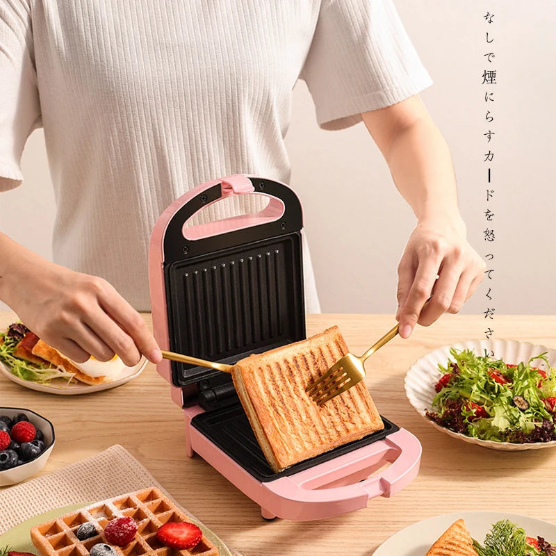 Sandwichera eléctrica portátil, máquina multifuncional para el hogar, antiadherente, para preparar desayunos, gofres y otros alimentos. Color rosa y rojo.